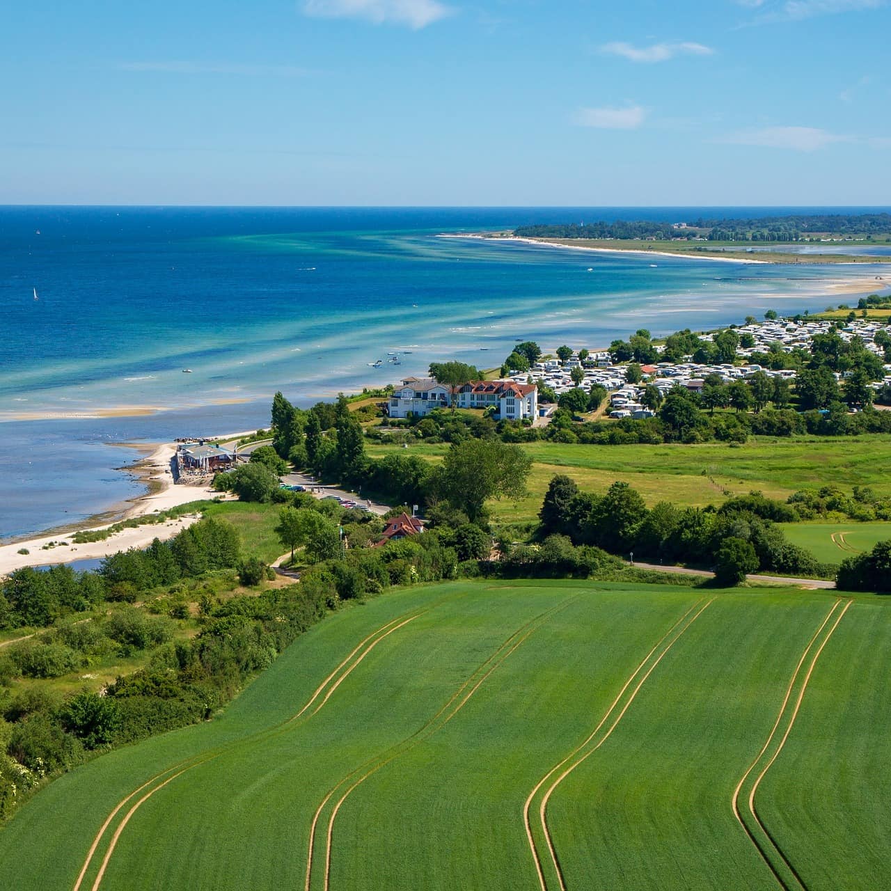 Blick von oben auf Laboe und die Felder der Umgebung, viele Häuser liegen direkt am Meer.
