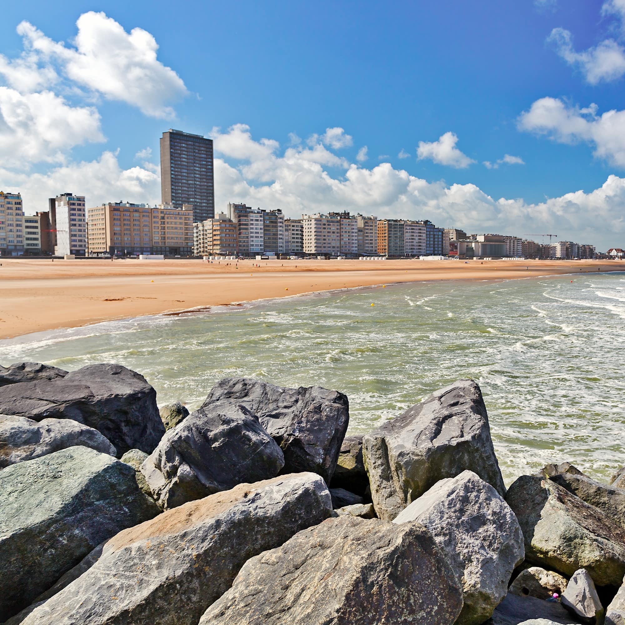 View from the sandy beach on the city. Summer day in Ostende, Belgium