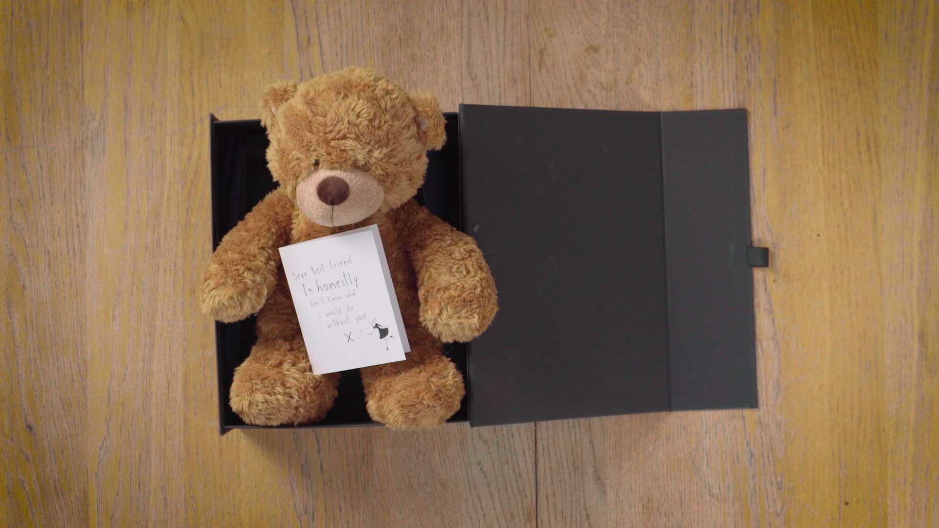 picture of a teddy bear with a letter in a box