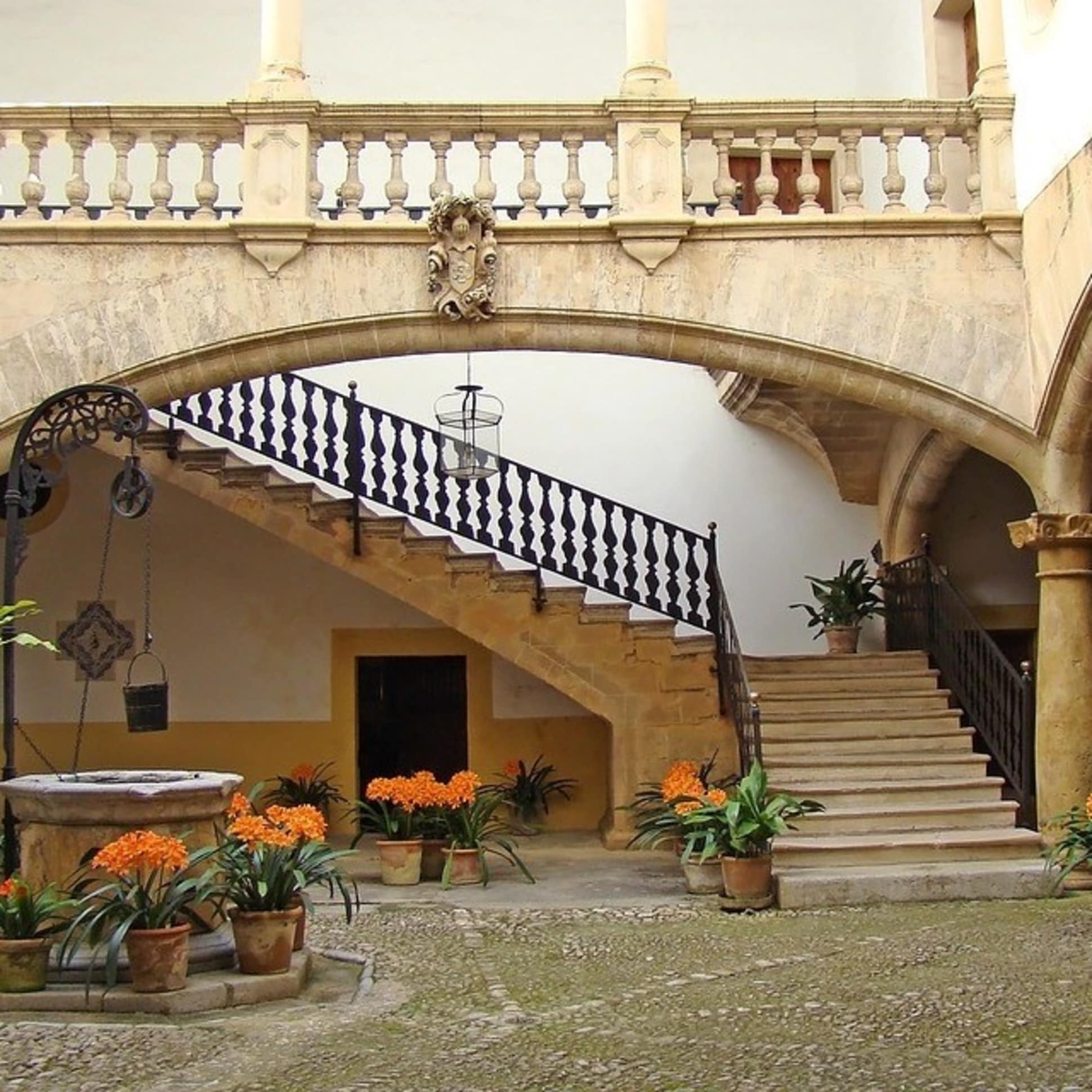 Schattenspendender, typisch spanischer Innenhof mit Blumen einer Finca auf Mallorca