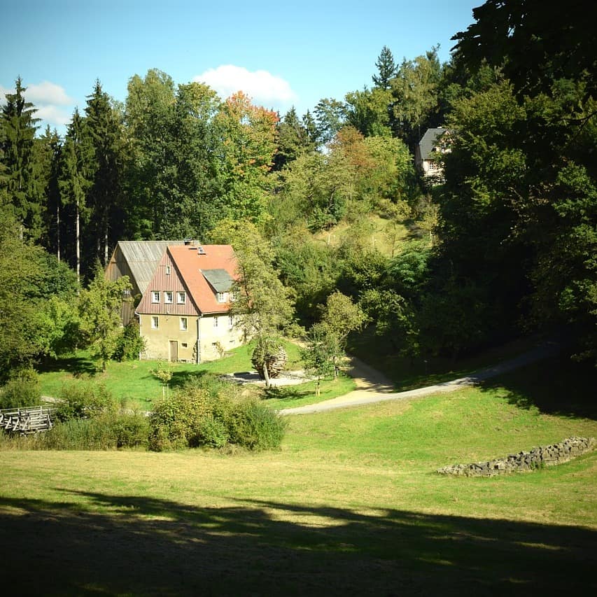 Ruhig gelegen und in mitten von der Natur – ein Haus in der Sächsischen Schweiz umgeben von Wald und einer Wiese.