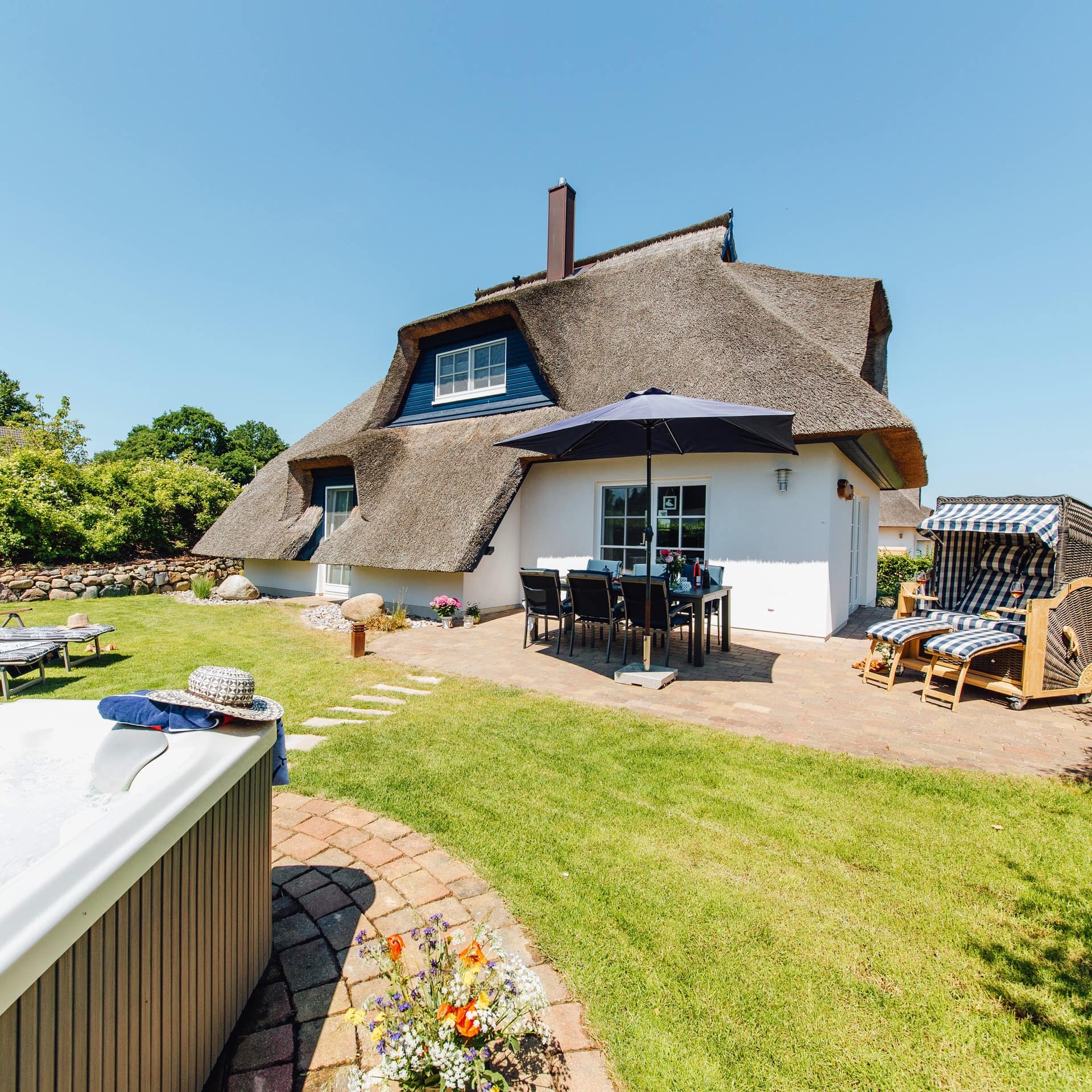 Luxus-Ferienhaus an der Ostsee mit Garten mit Stühlen, Strandkorb und Whirlpool