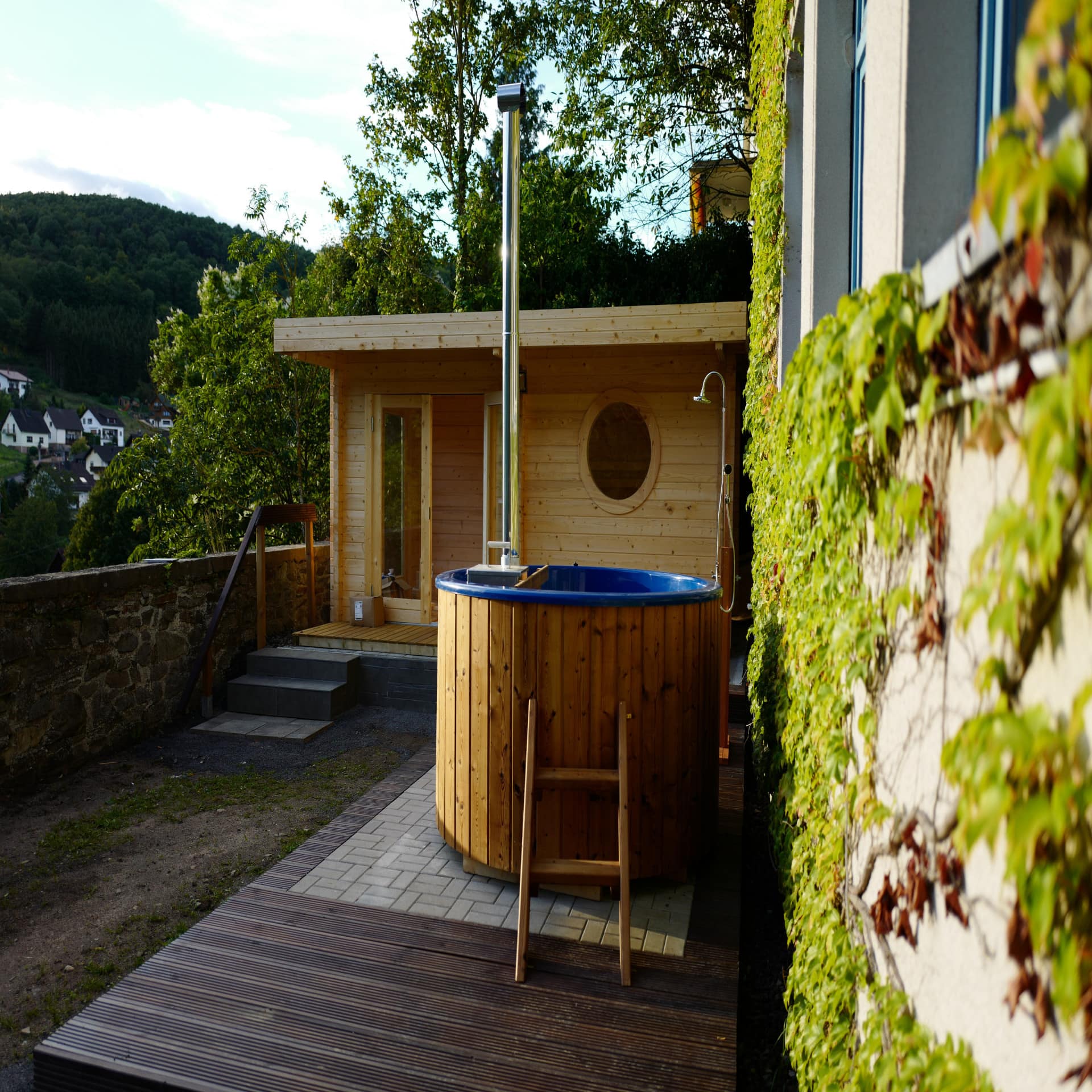 Sauna mit Tauchbecken in einem Garten.